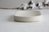 Modern ceramic white oval bowl with curved line pattern