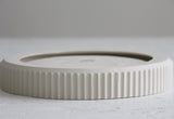 Modern ceramic white oval bowl with curved line pattern