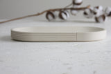 Modern ceramic white oval bowl with curved line pattern