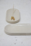 Modern ceramic white oval bowl with curved line pattern